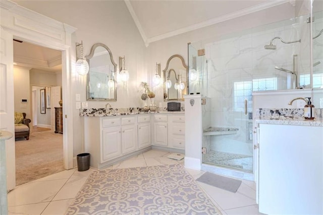 bathroom with crown molding, lofted ceiling, vanity, and a shower with shower door