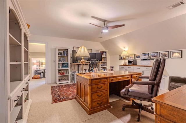 carpeted office featuring lofted ceiling and ceiling fan