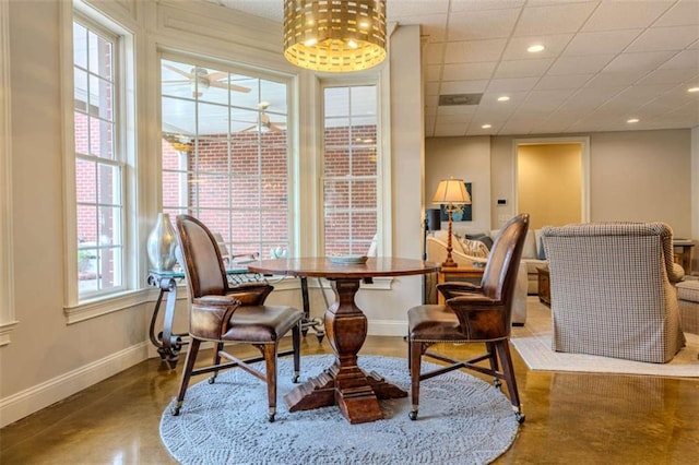 living area featuring a drop ceiling