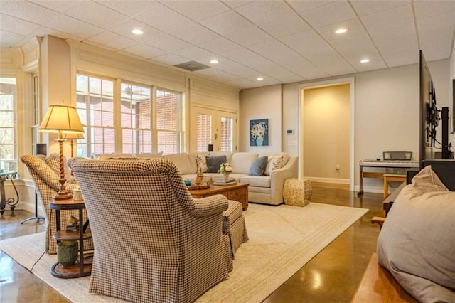 living room with a drop ceiling