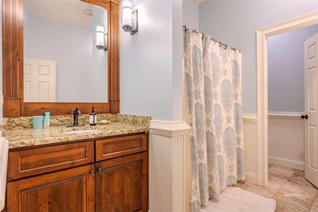 bathroom featuring vanity and a shower with shower curtain