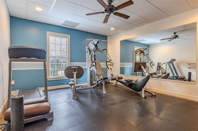 workout room with a drop ceiling and ceiling fan