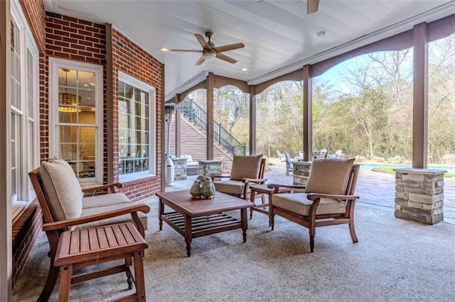 sunroom / solarium featuring ceiling fan