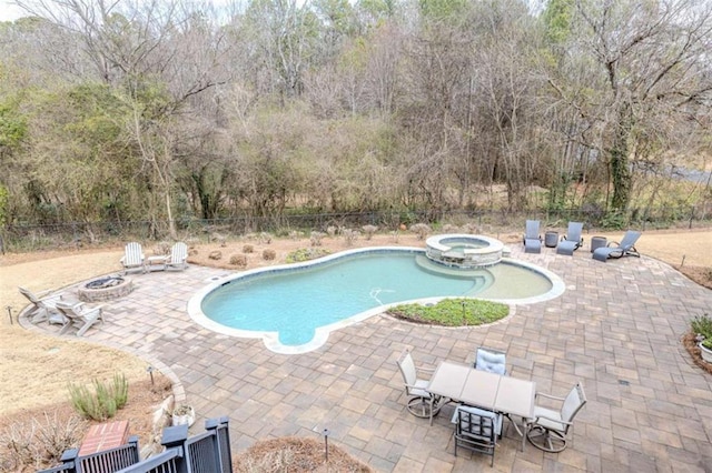 view of pool with an in ground hot tub, an outdoor fire pit, and a patio