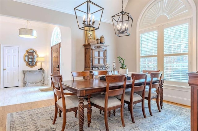 dining area featuring ornamental molding and light wood-type flooring