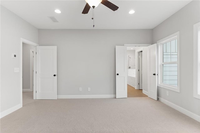 unfurnished bedroom featuring ceiling fan and light colored carpet