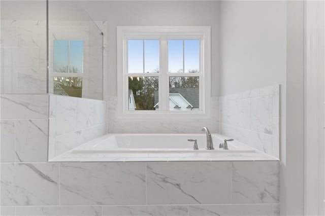 bathroom featuring tiled tub