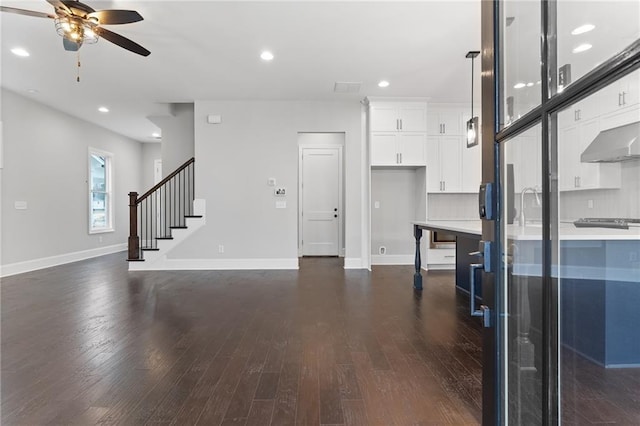 kitchen with white cabinetry, dark hardwood / wood-style floors, tasteful backsplash, ceiling fan, and pendant lighting