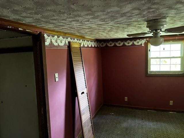 empty room with ceiling fan and carpet floors