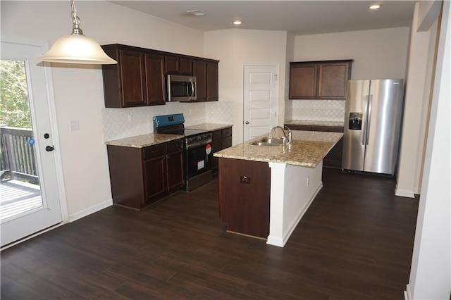 kitchen featuring light stone counters, stainless steel appliances, a sink, dark brown cabinets, and dark wood-style floors