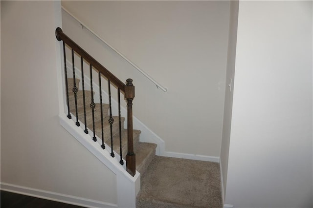 staircase with carpet floors and baseboards