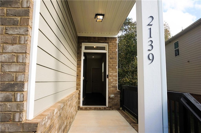 property entrance with brick siding