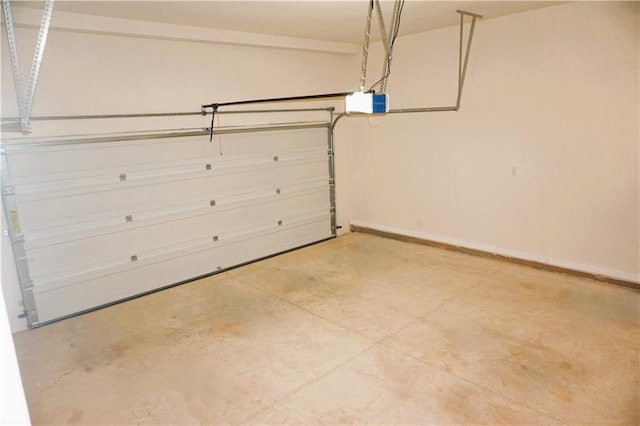 garage featuring a garage door opener and baseboards