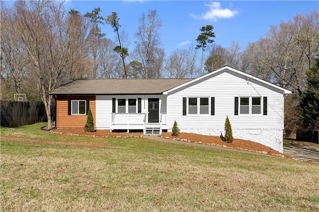 single story home with a shingled roof, a front yard, and fence