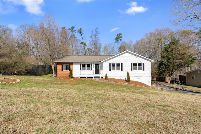 ranch-style house with a front yard and fence