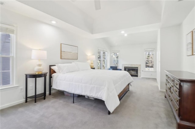 bedroom with recessed lighting, baseboards, a high end fireplace, and light colored carpet