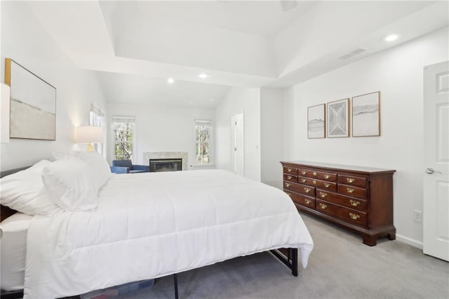 bedroom with recessed lighting, visible vents, a glass covered fireplace, carpet flooring, and baseboards