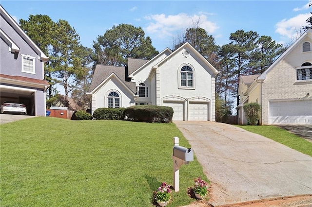 traditional-style home with a garage, stucco siding, concrete driveway, and a front yard