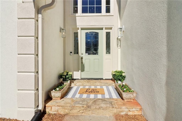 doorway to property with stucco siding