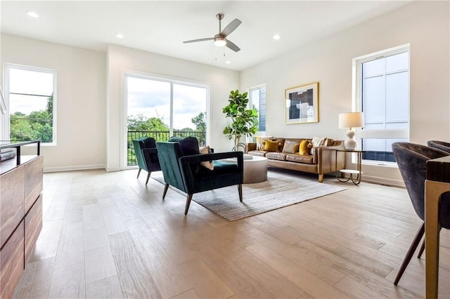 living room featuring light hardwood / wood-style floors and ceiling fan