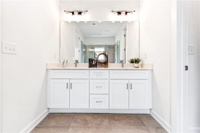 bathroom featuring vanity, tile patterned floors, and a shower with shower door