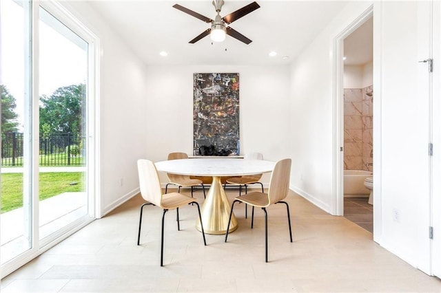 dining area with ceiling fan and light tile patterned flooring