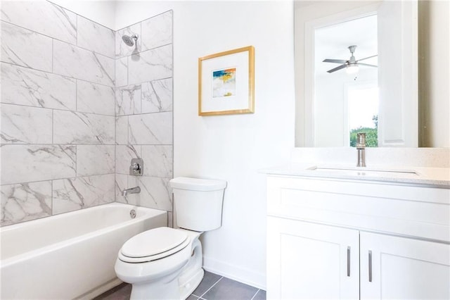 full bathroom featuring ceiling fan, tiled shower / bath combo, tile patterned flooring, toilet, and vanity