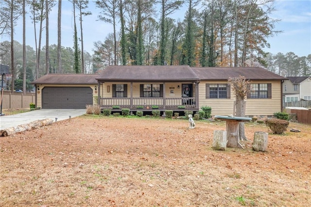 ranch-style home with a porch and a garage