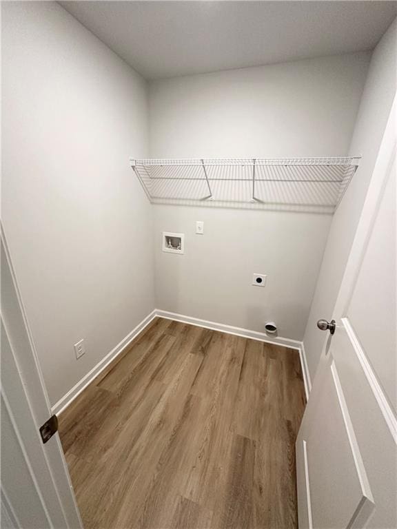 laundry room with baseboards, washer hookup, laundry area, wood finished floors, and electric dryer hookup