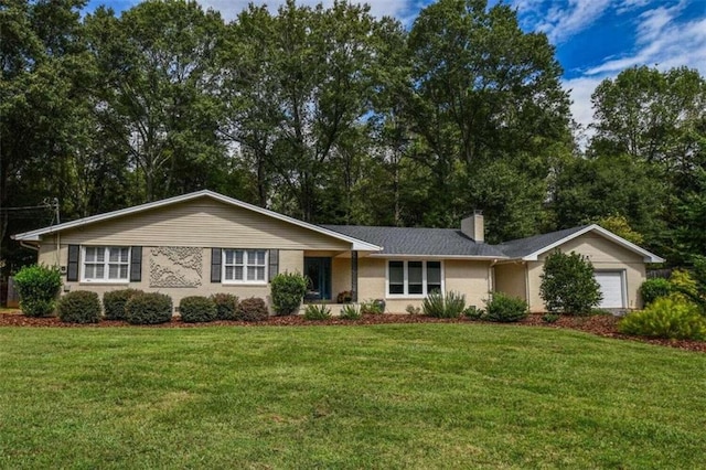 single story home featuring a garage and a front yard