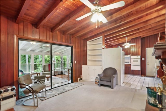 living room with beamed ceiling, light tile patterned floors, wooden ceiling, and wood walls