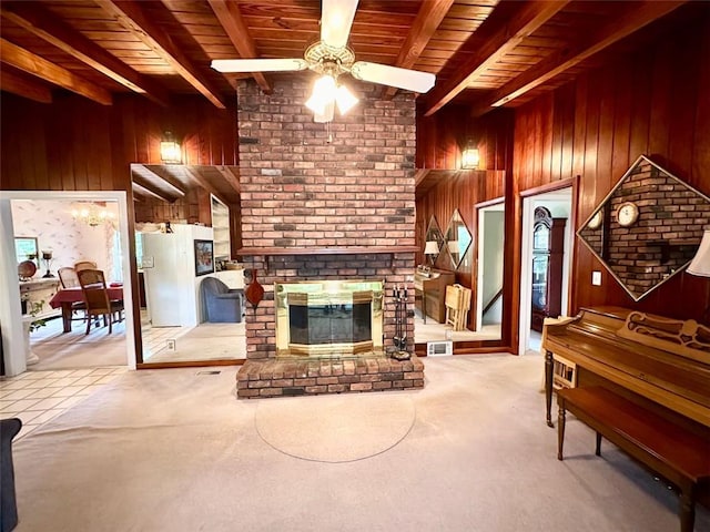 tiled living room with beam ceiling, wooden walls, and wood ceiling