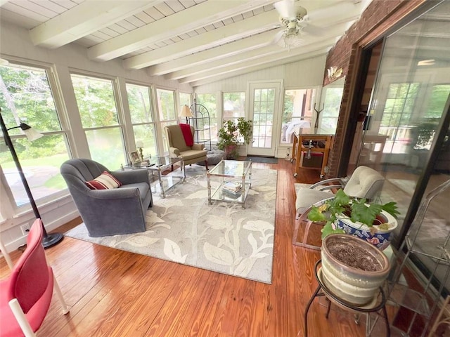 sunroom / solarium featuring vaulted ceiling with beams, a healthy amount of sunlight, and ceiling fan