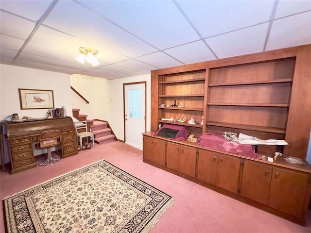 carpeted office space featuring a drop ceiling