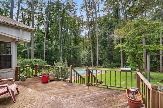 deck featuring a lawn and a swimming pool