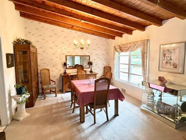 carpeted dining room featuring beamed ceiling, an inviting chandelier, and wooden ceiling