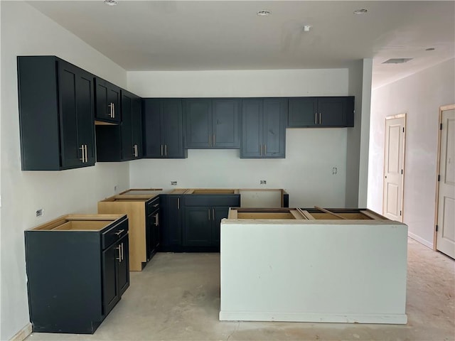 kitchen with concrete flooring and a center island