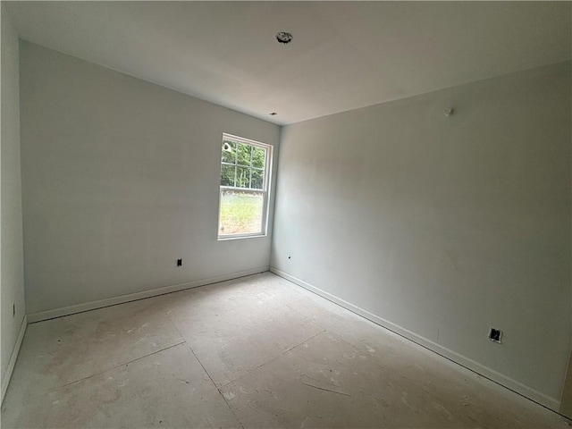 empty room featuring baseboards