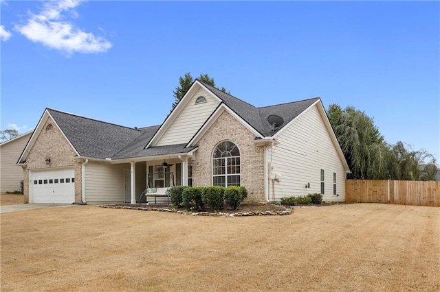 view of front of property with a ceiling fan, concrete driveway, an attached garage, fence, and brick siding