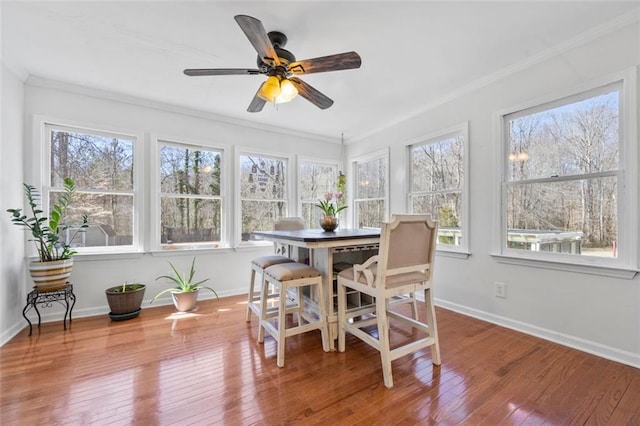 sunroom / solarium with a ceiling fan and a healthy amount of sunlight