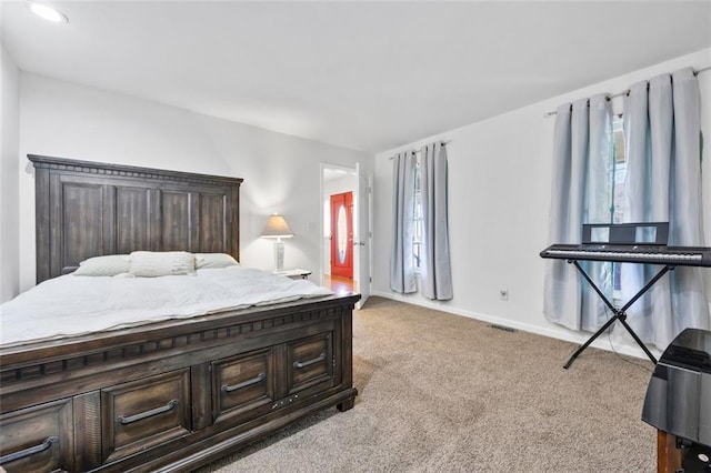 carpeted bedroom featuring visible vents and baseboards