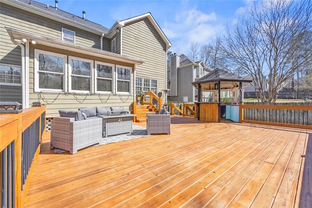 wooden terrace featuring a gazebo and outdoor lounge area