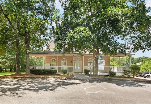 view of front of home featuring french doors and covered porch