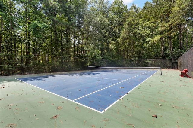 view of tennis court featuring fence