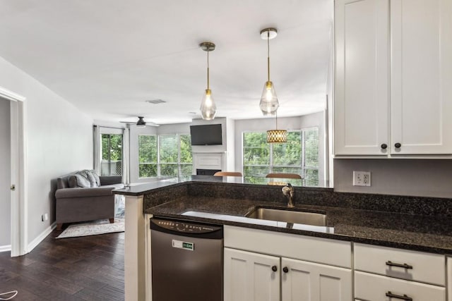 244 13th St NE Unit 302, Atlanta, GA 30309 - kitchen with dishwasher, open floor plan, dark wood-type flooring, a fireplace, and white cabinets