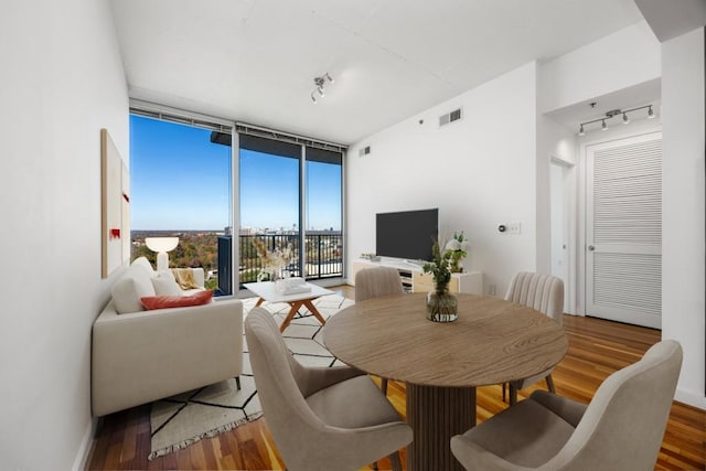 361 17th St NW Unit 1618, Atlanta, GA 30363 - dining area featuring floor to ceiling windows, rail lighting, and hardwood / wood-style flooring