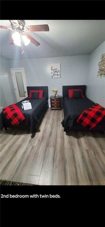 bedroom with ceiling fan and hardwood / wood-style floors