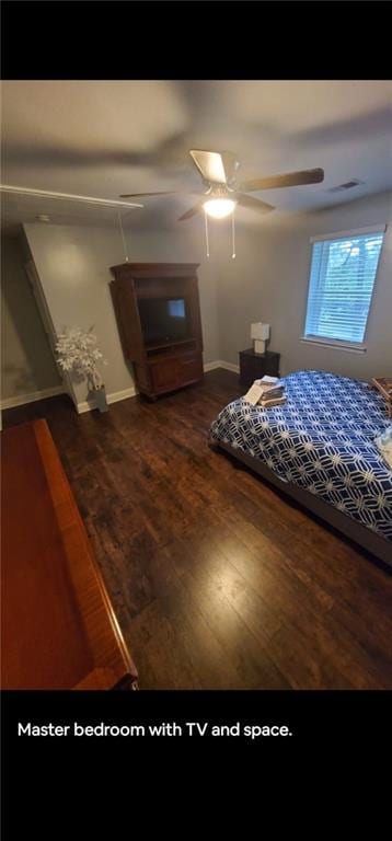 unfurnished bedroom featuring ceiling fan and dark wood-type flooring