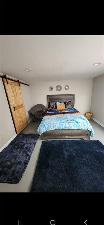 carpeted bedroom featuring a barn door