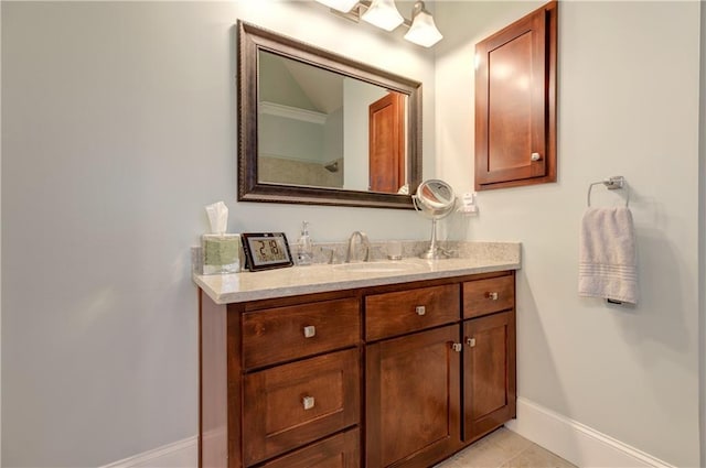 bathroom featuring vanity, baseboards, and tile patterned floors